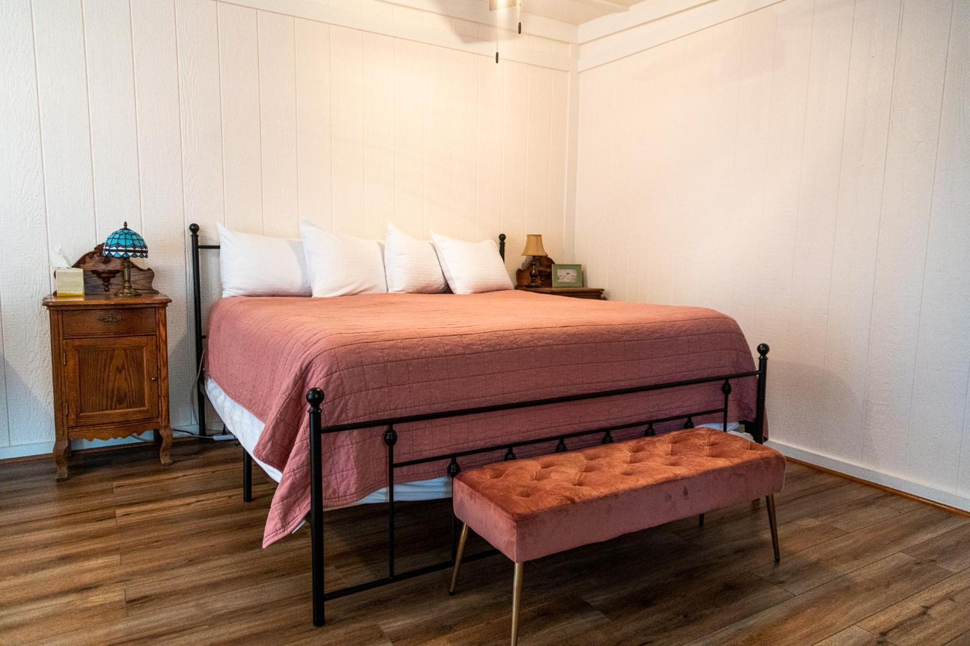 Sagebrush Inn Tombstone Room photo A bedroom with a bed and a bench